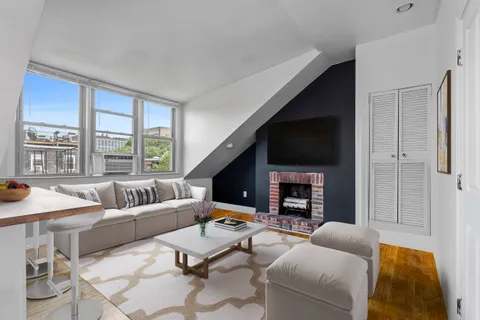 a living room with fireplace furniture and a flat screen tv