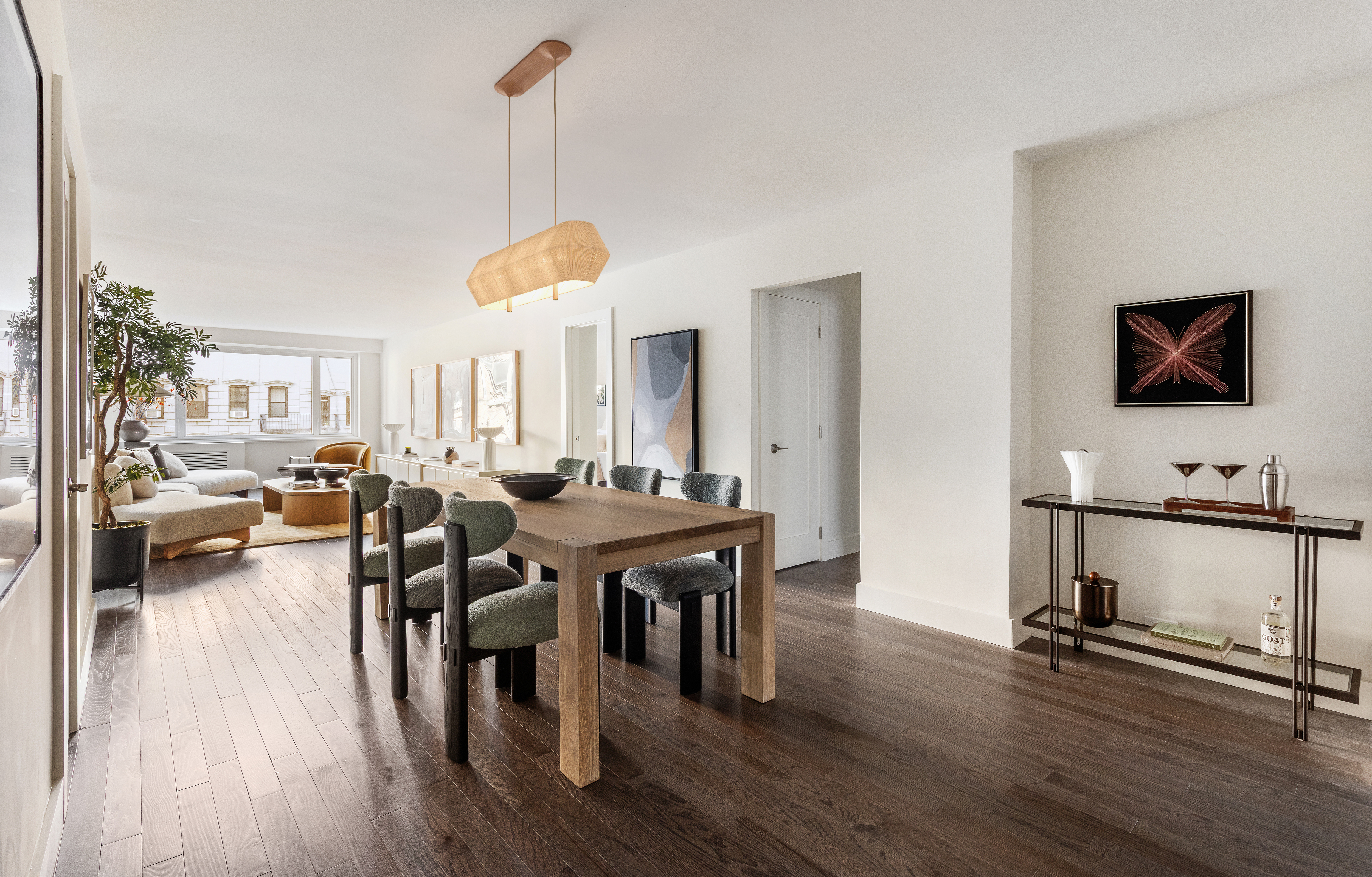 411 East 53rd Street, Unit 6L Manhattan, NY 10022 - Photo 4 of 12 a living room with furniture a wooden floor and a flat screen tv