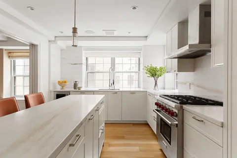 a kitchen with stainless steel appliances a sink a stove a counter space and a window