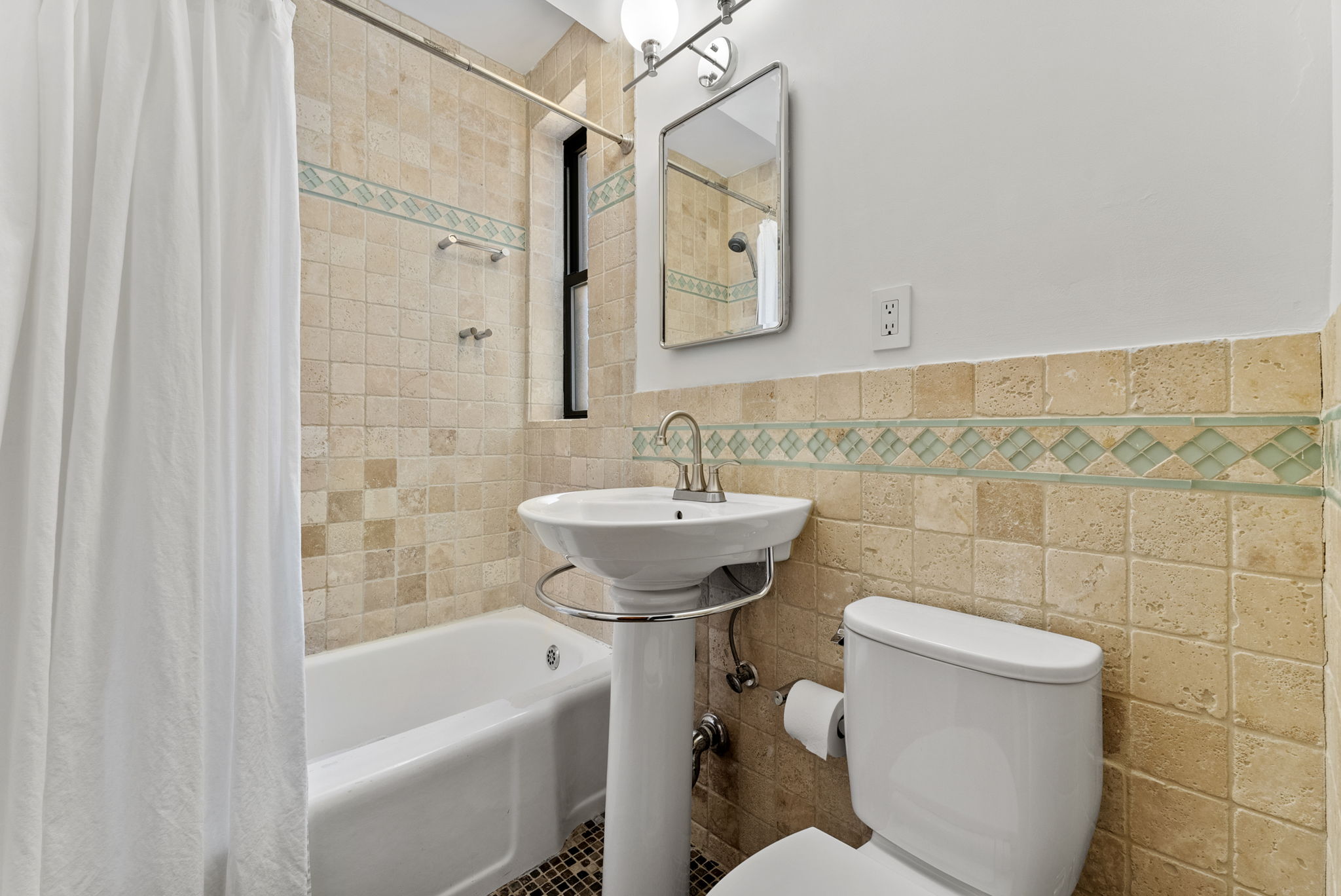 675 Academy Street, Unit 5E Manhattan, NY 10034 - Photo 9 of 10 a bathroom with a sink a toilet and shower