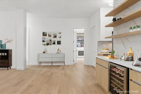 a kitchen with stainless steel appliances a white cabinets and a wooden floor