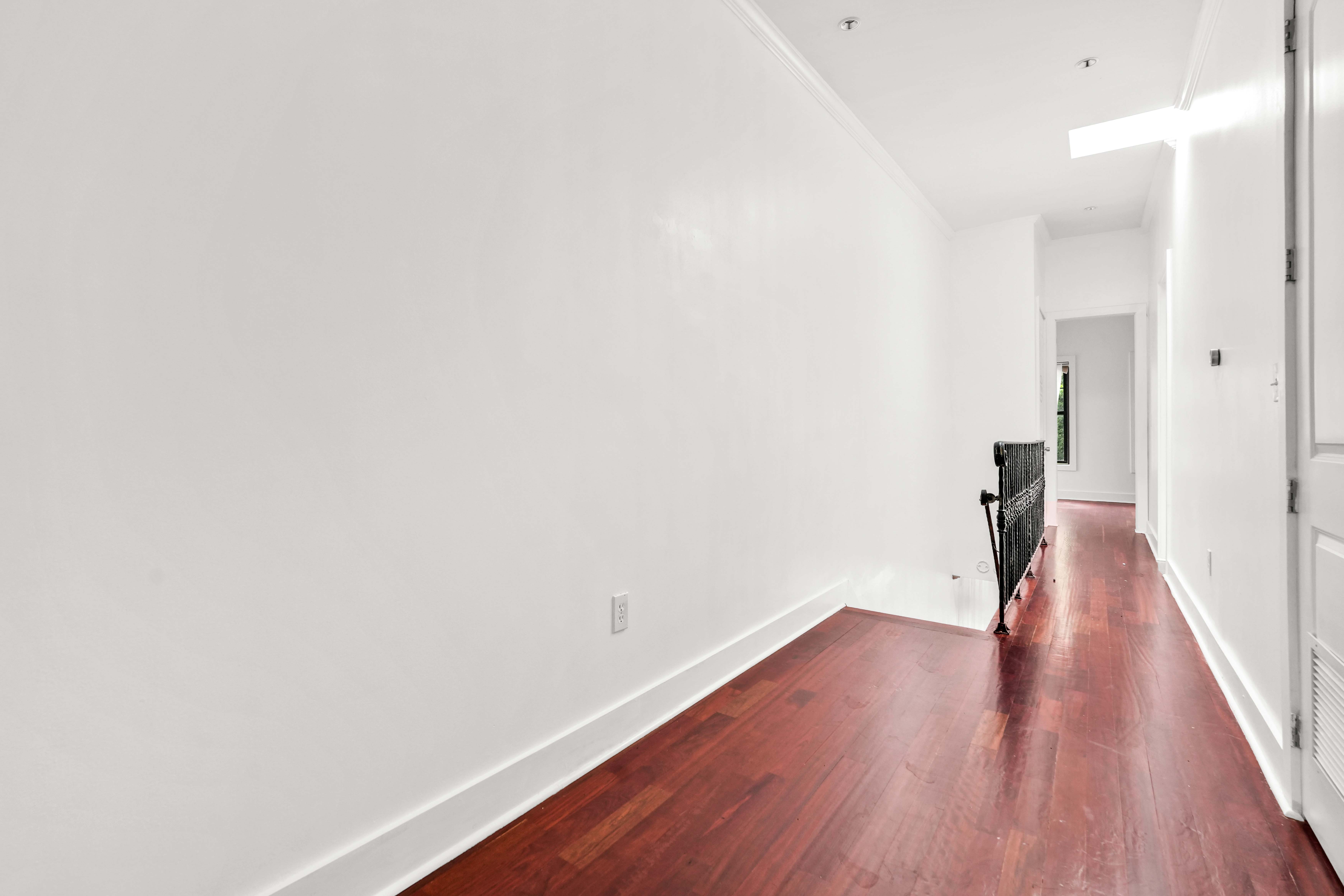 17 A Suydam Place, Unit 2 Brooklyn, NY 11233 - Photo 12 of 28 a hallway with wooden floor and a bathroom view