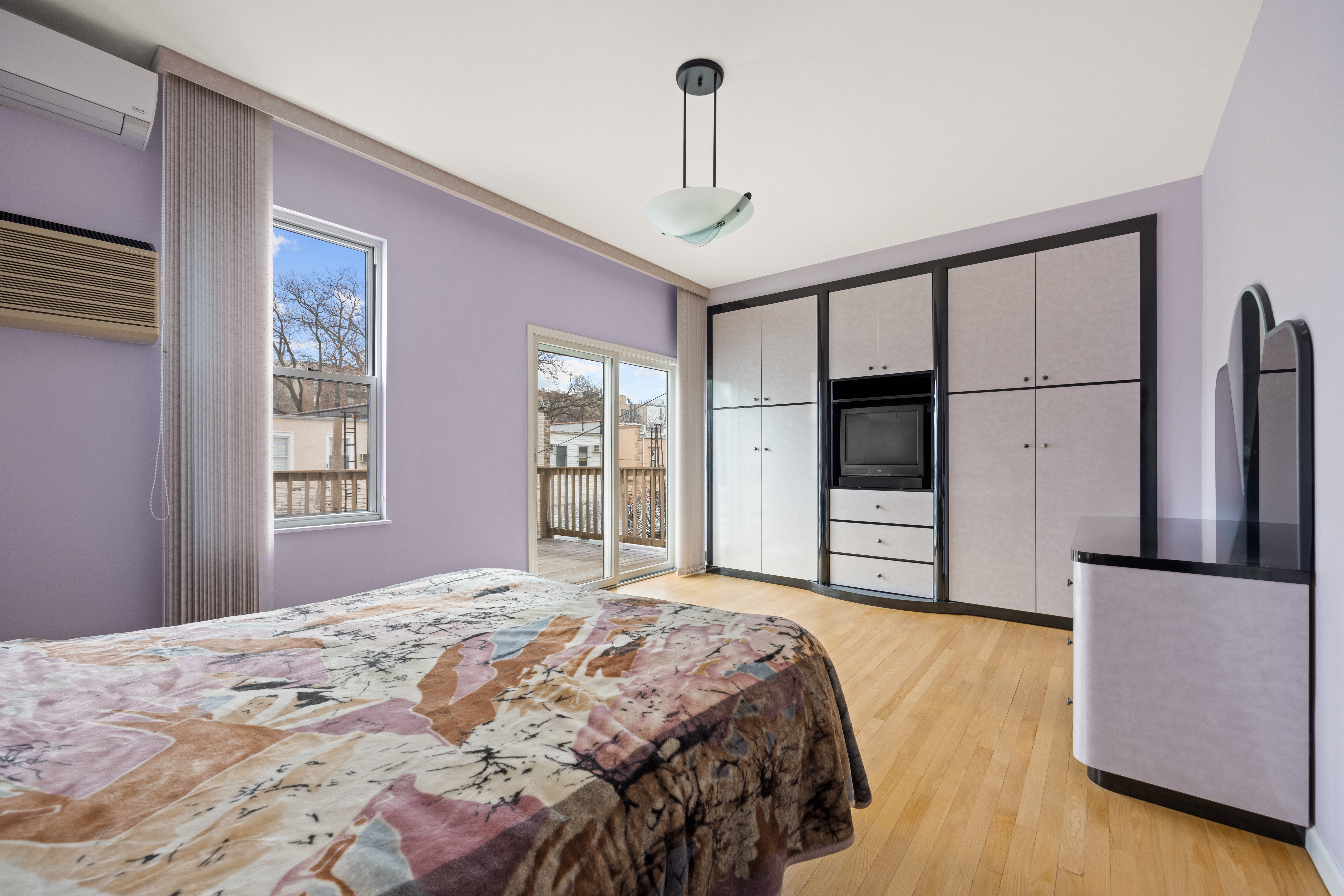 1635 West 12th Street Brooklyn, NY 11223 - Photo 7 of 21 a bedroom with a large bed and a window