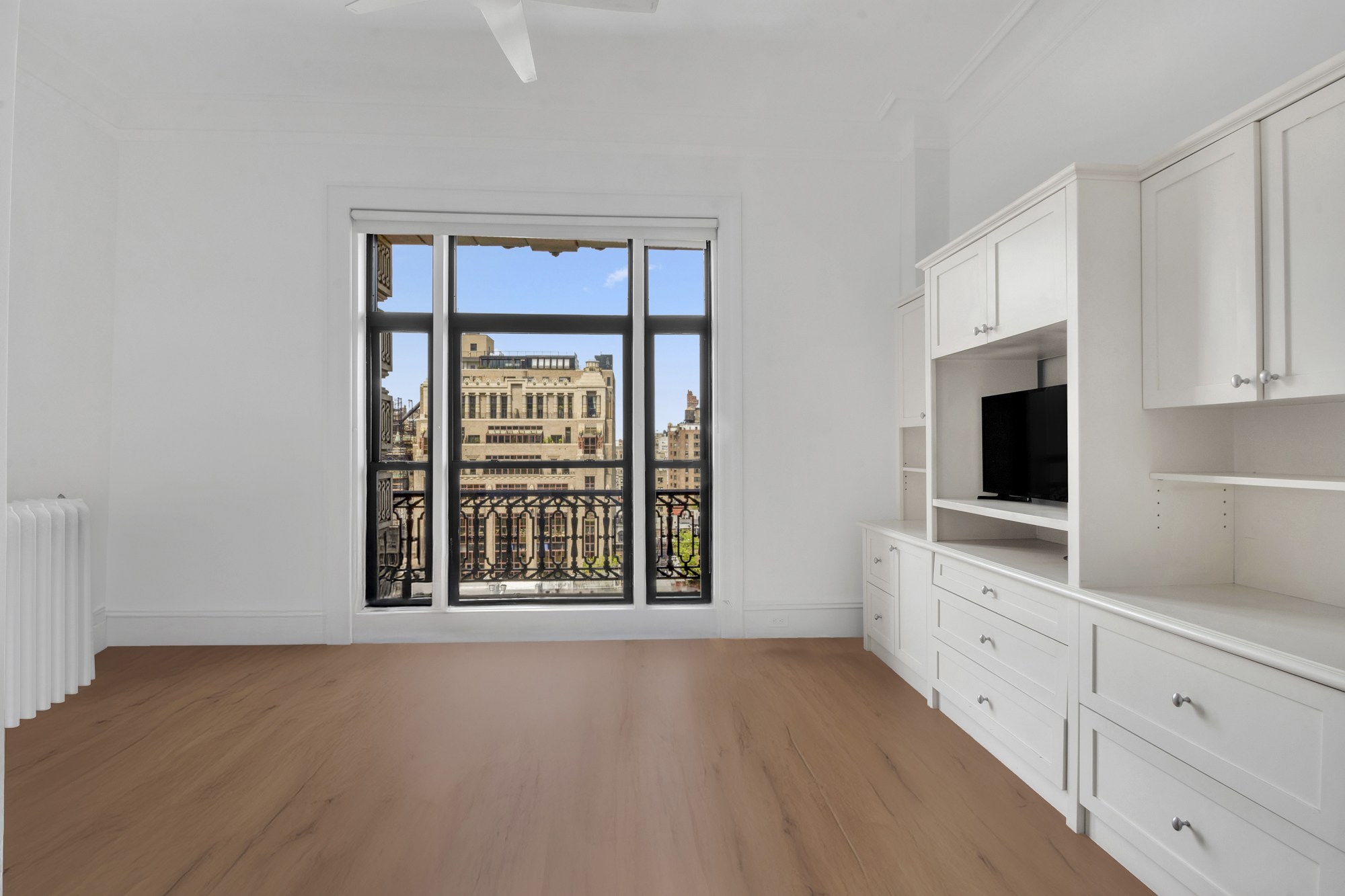 140 West 69th Street, Unit 107A Manhattan, NY 10023 - Photo 2 of 15 a view of an empty room with a fireplace and a window