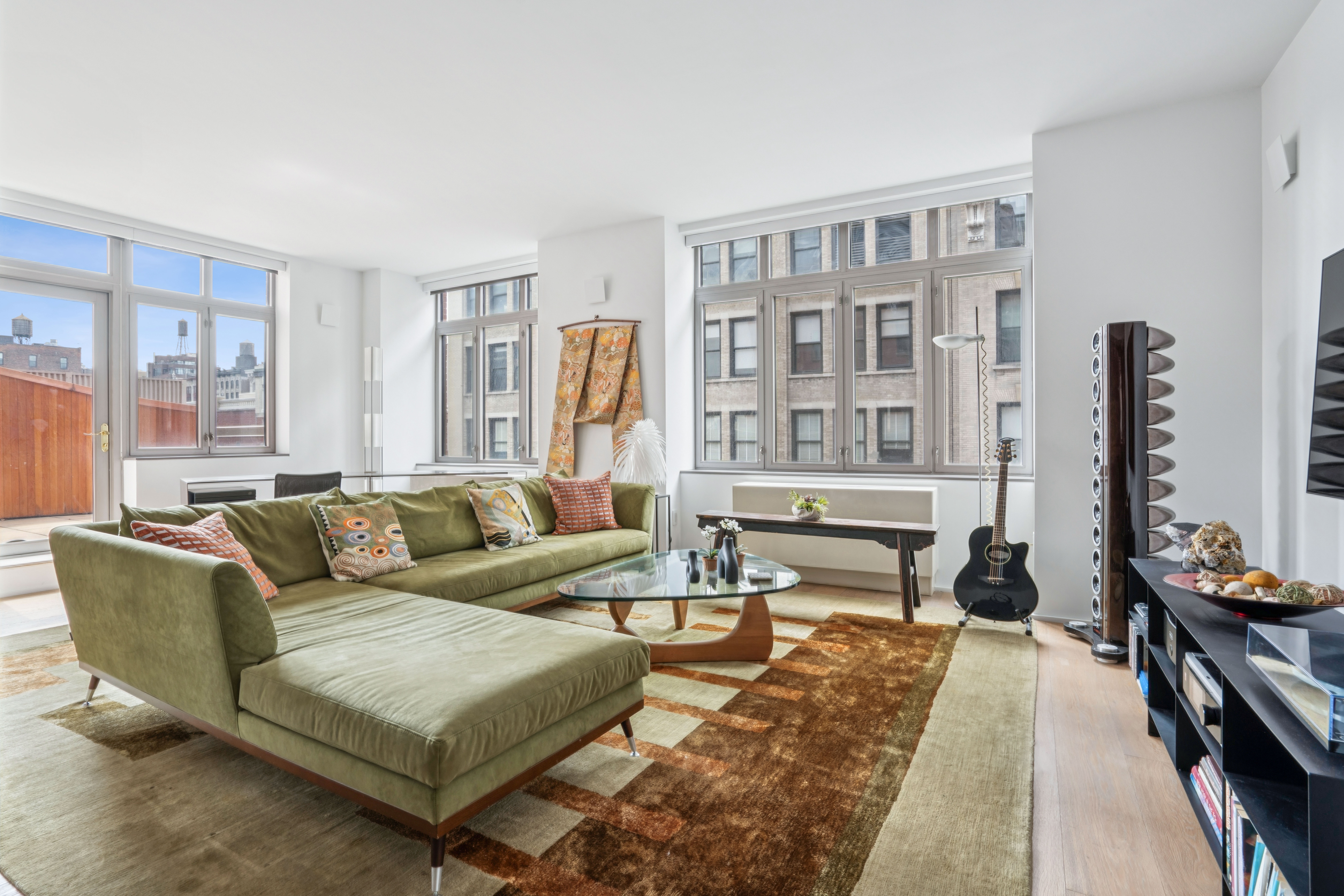 125 West 22nd Street, Unit 10A Manhattan, NY 10011 - Photo 4 of 12 a living room with furniture and a flat screen tv