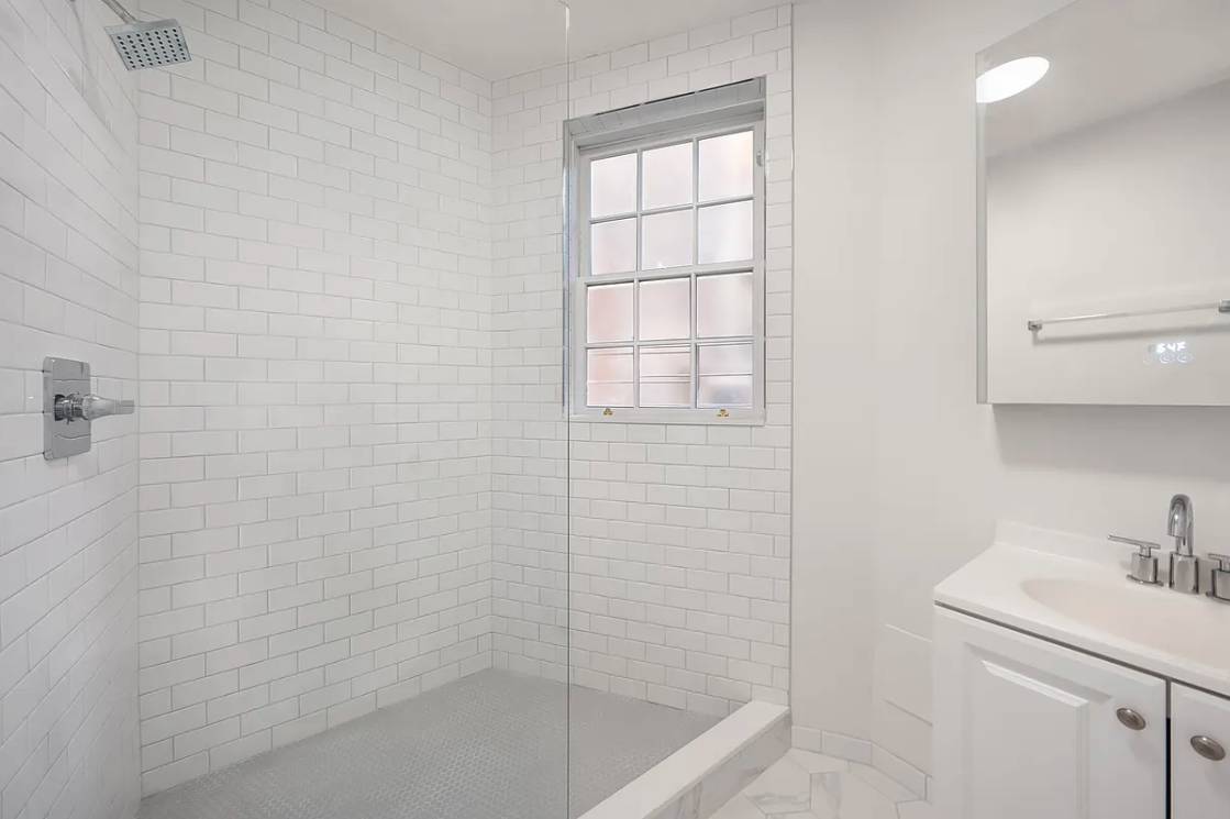 151 West 80th Street, Unit 4F Manhattan, NY 10024 - Photo 7 of 8 a bathroom with a sink a toilet and shower