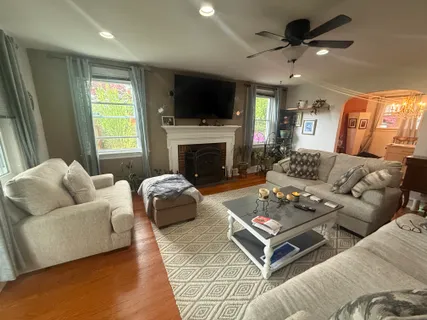a living room with furniture a fireplace and a flat screen tv