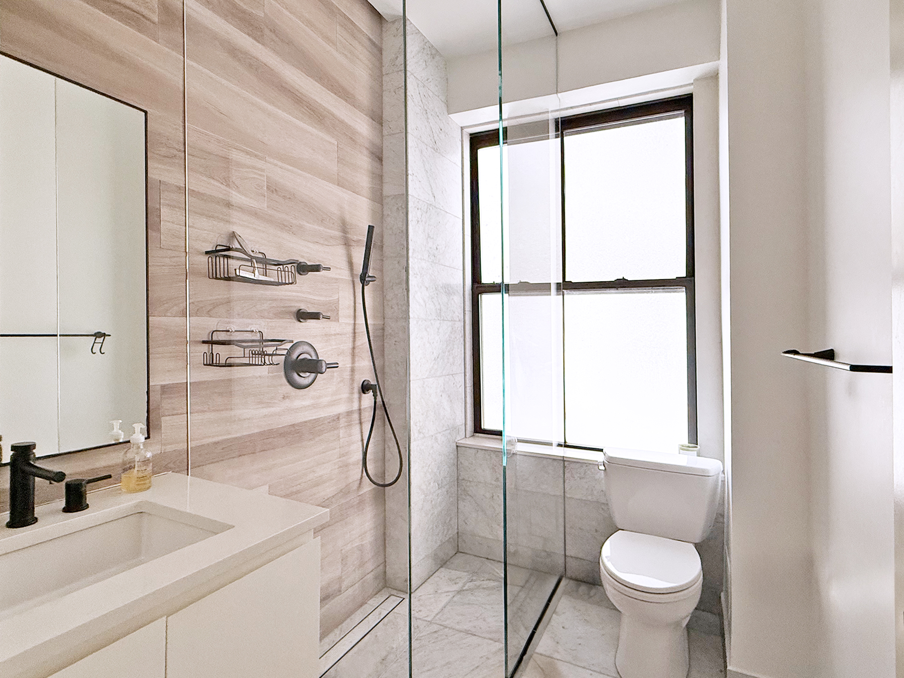 418 Central Park West, Unit 30 Manhattan, NY 10025 - Photo 9 of 12 a bathroom with a sink toilet and shower