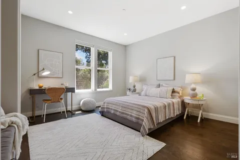 a bedroom with a large bed and a large window