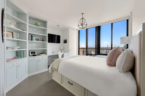 a bedroom with a large bed and a tv