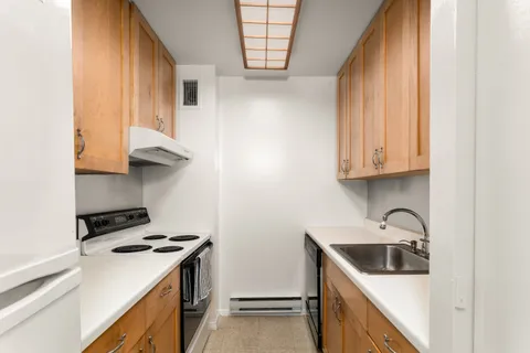 a kitchen with stainless steel appliances granite countertop a sink and a stove top oven