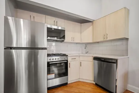 a kitchen with stainless steel appliances a refrigerator stove and microwave