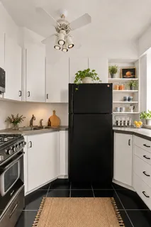 a kitchen with granite countertop a refrigerator and a stove