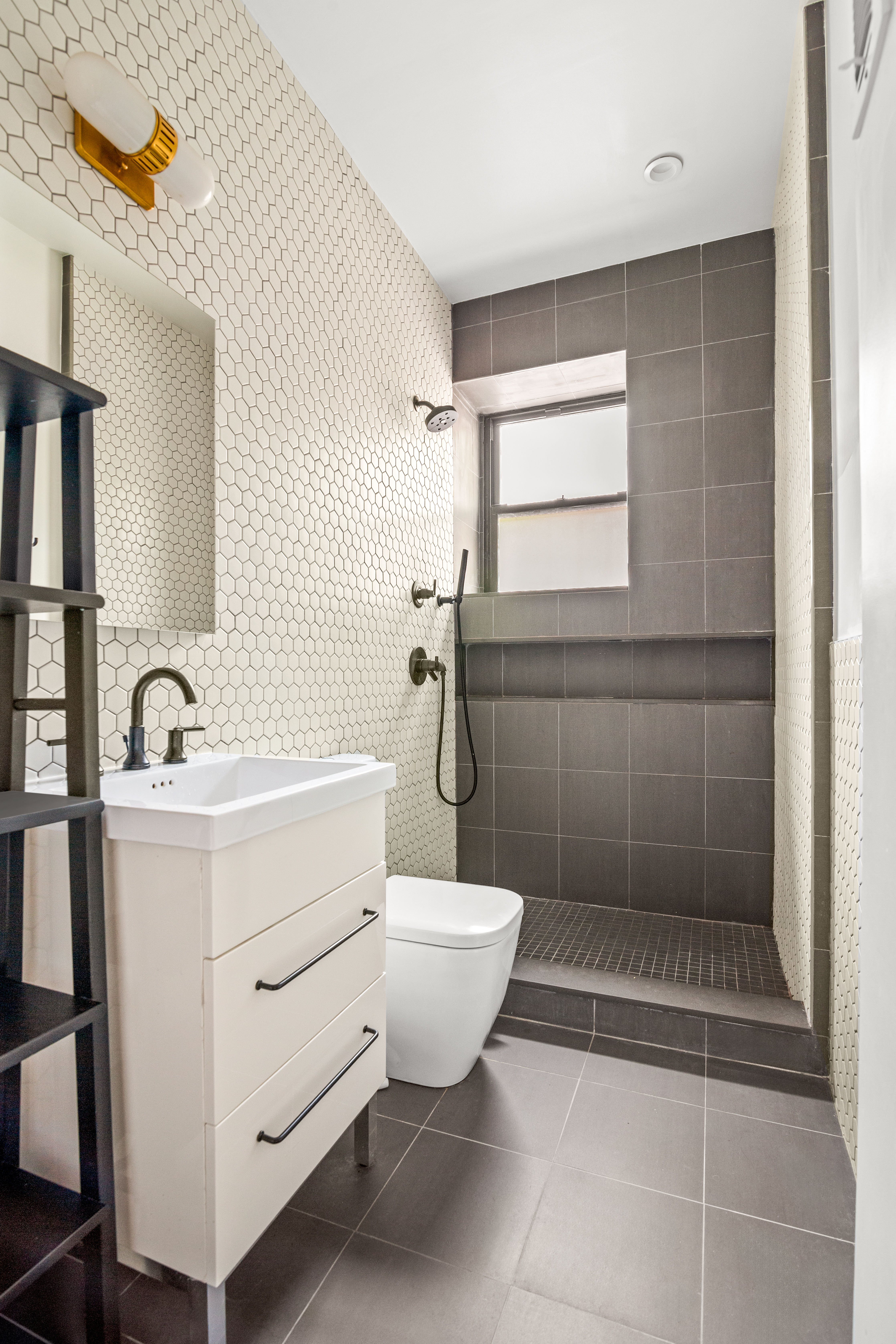 170 East 94th Street, Unit 1C Manhattan, NY 10128 - Photo 8 of 9 a bathroom with a sink toilet and shower