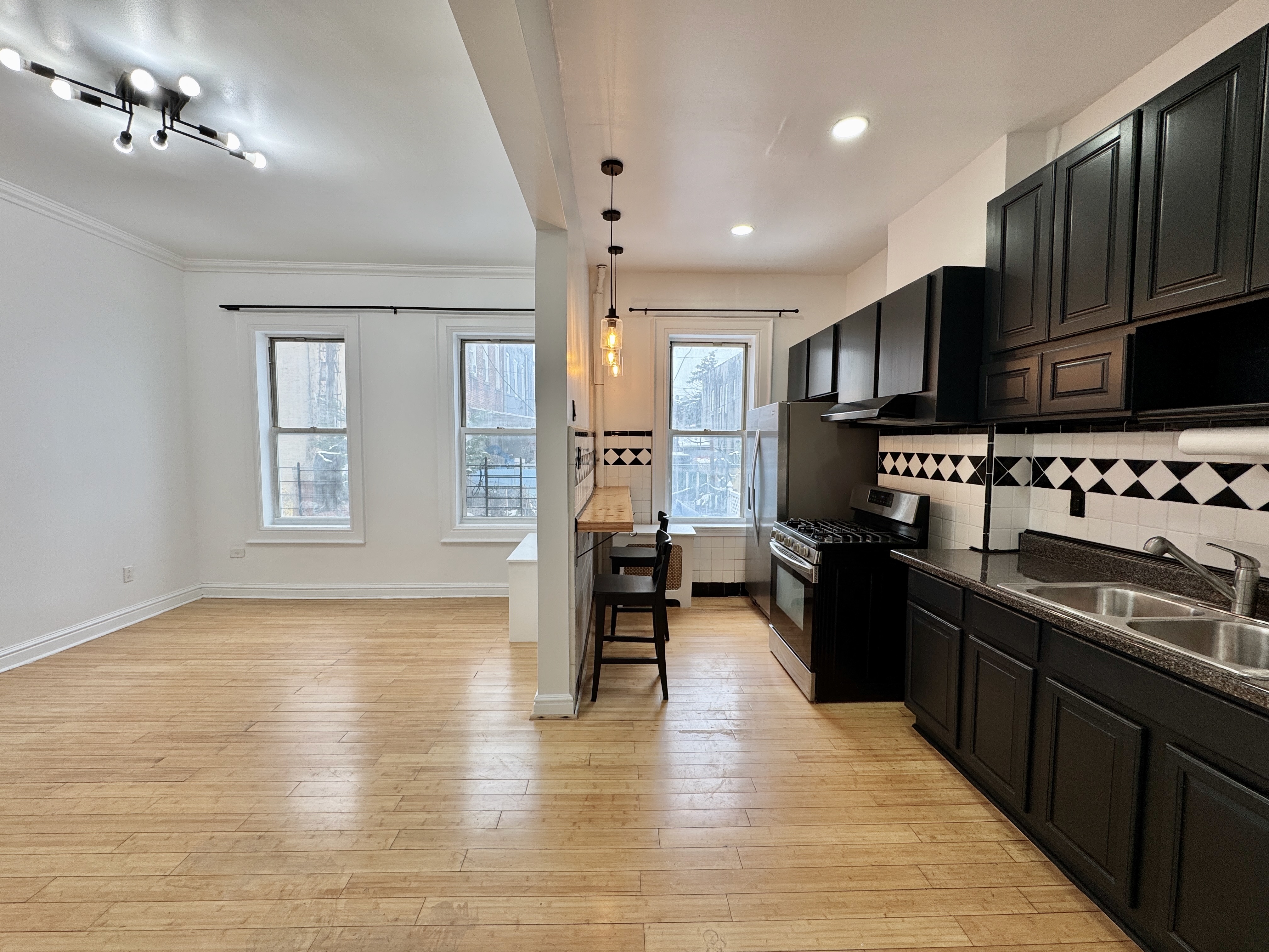 347 Berriman Street, Unit 1 Brooklyn, NY 11208 - Photo 5 of 6 a kitchen with stainless steel appliances granite countertop a sink stove and refrigerator