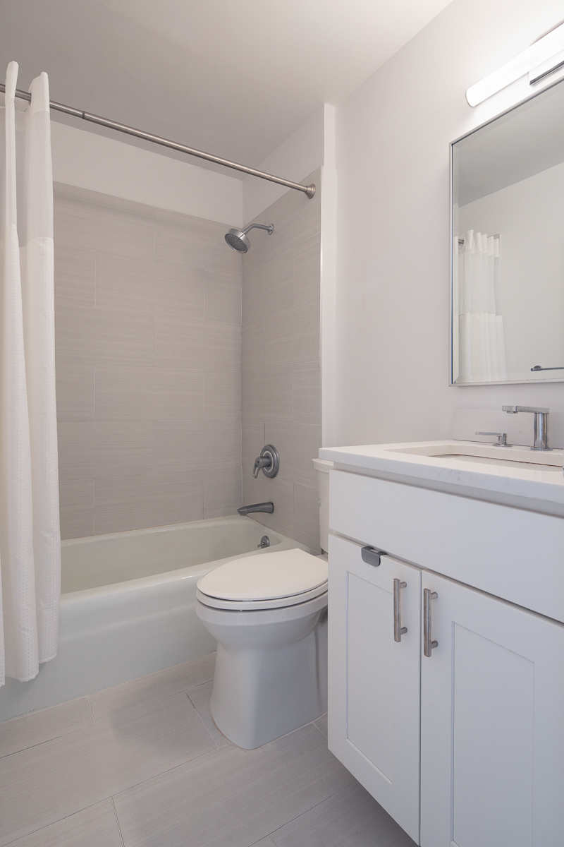 35 East 10th Street, Unit 4J Manhattan, NY 10003 - Photo 6 of 19 a bathroom with a sink a toilet and shower