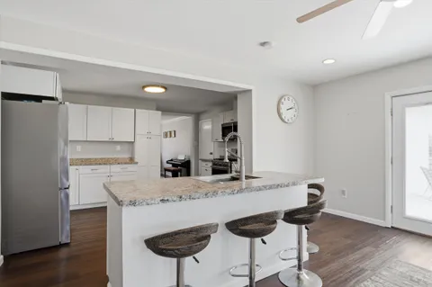 a kitchen with white cabinets and stainless steel appliances