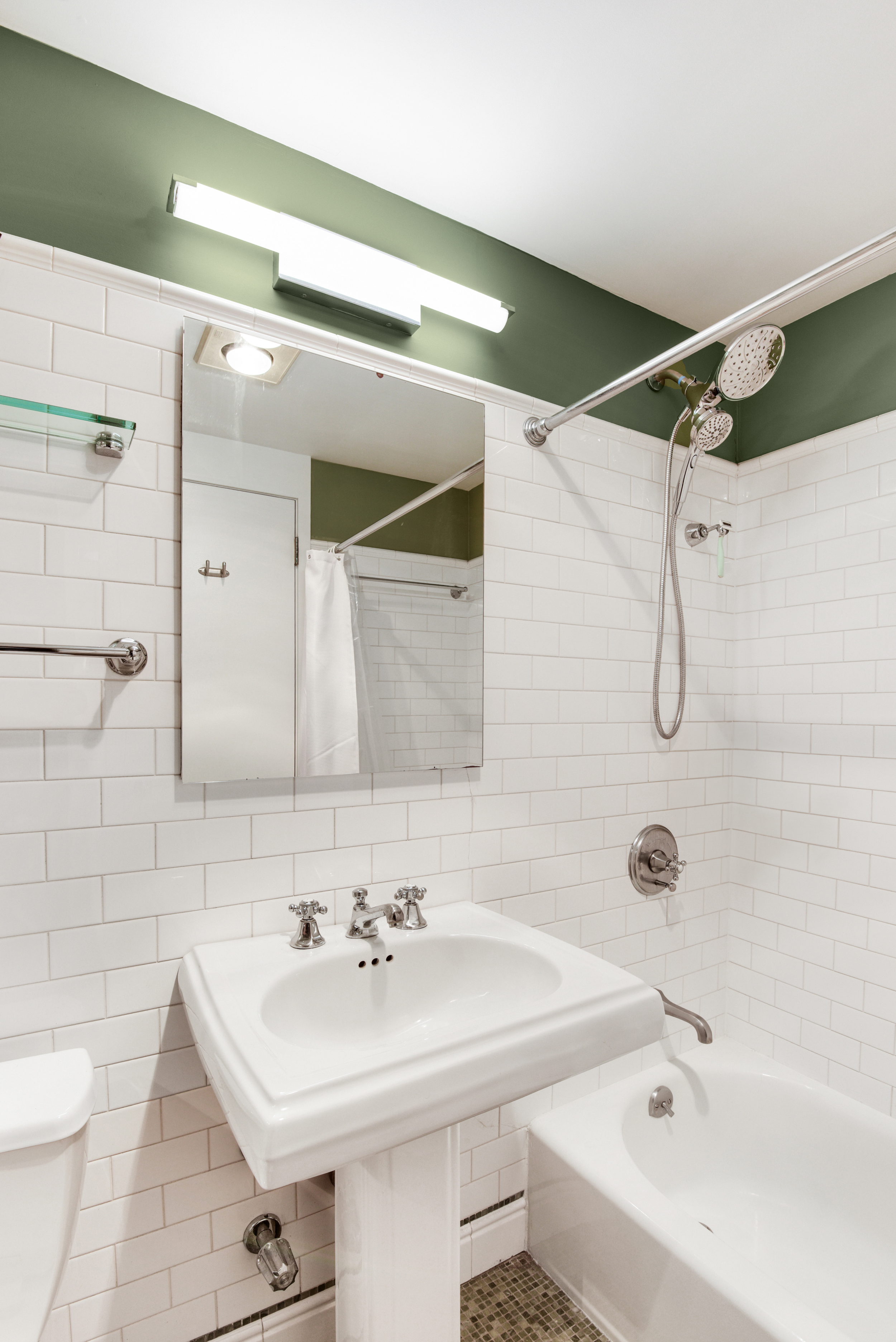 23 Waverly Place, Unit 5U Manhattan, NY 10003 - Photo 8 of 13 a bathroom with a sink a toilet and shower