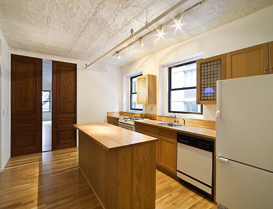 107 West 26th Street, Unit 4 Manhattan, NY 10001 - Photo 8 of 14 a kitchen with stainless steel appliances a sink and a refrigerator