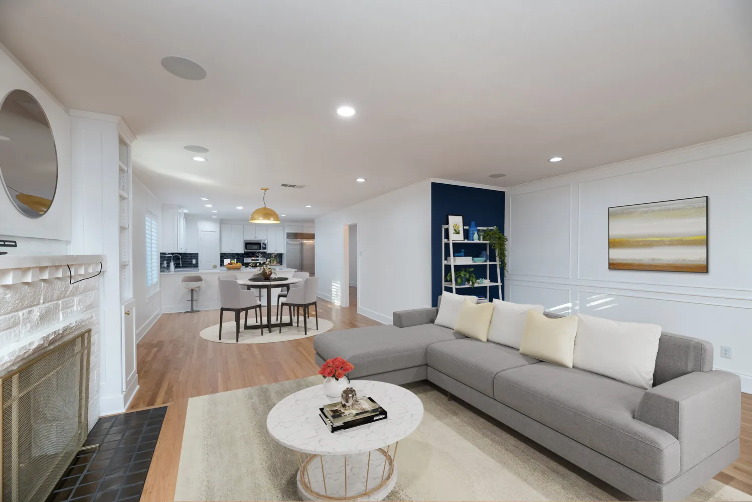 a living room with furniture kitchen view and a fireplace