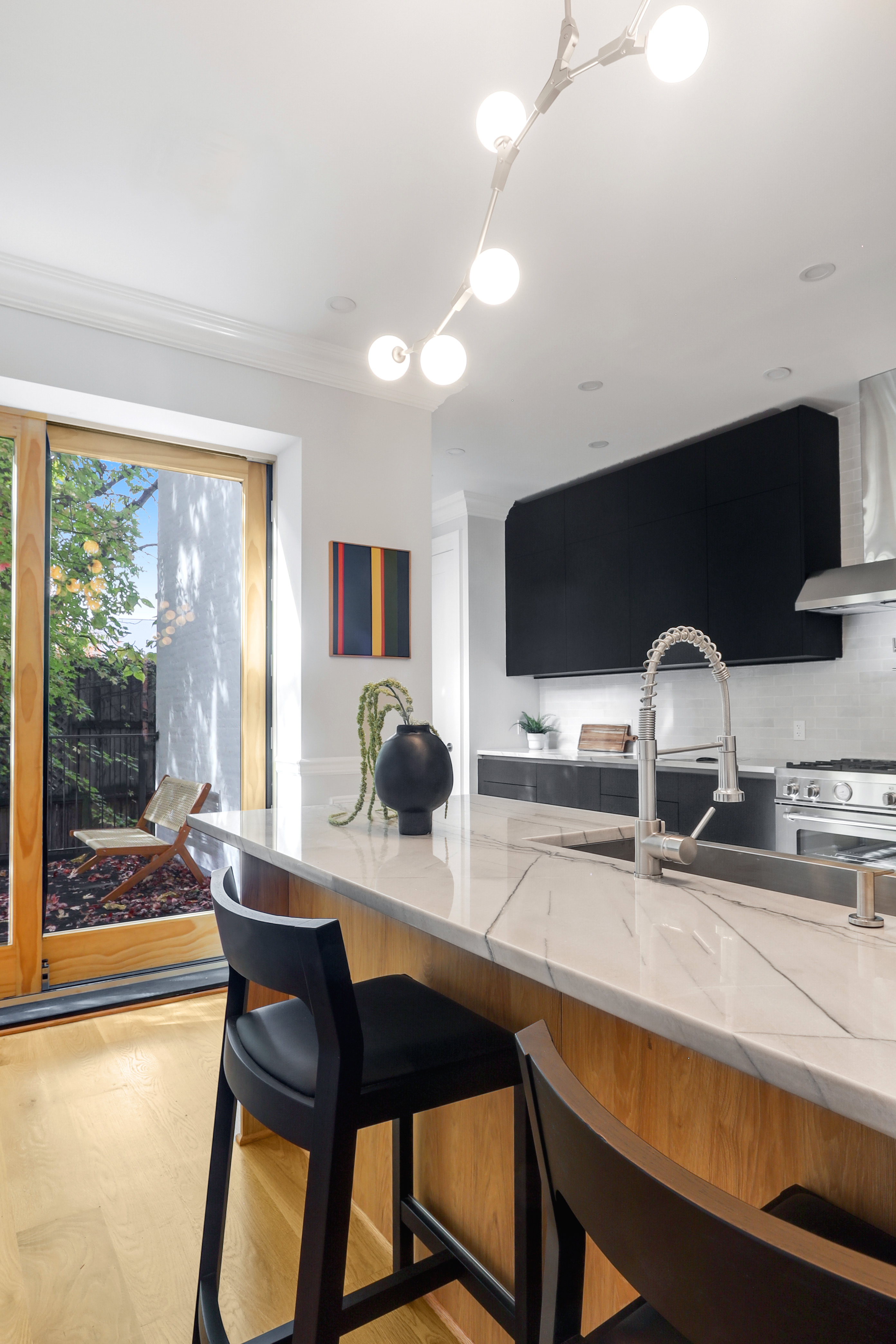220 Lewis Avenue Brooklyn, NY 11221 - Photo 8 of 22 a kitchen with a table and chairs in it