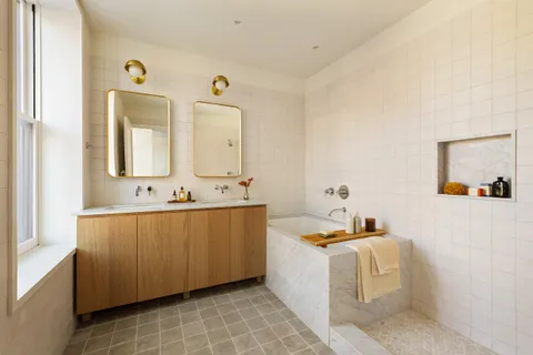 a living room with a sink and mirror