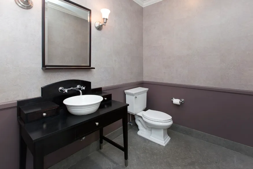 a bathroom with a toilet a sink and mirror