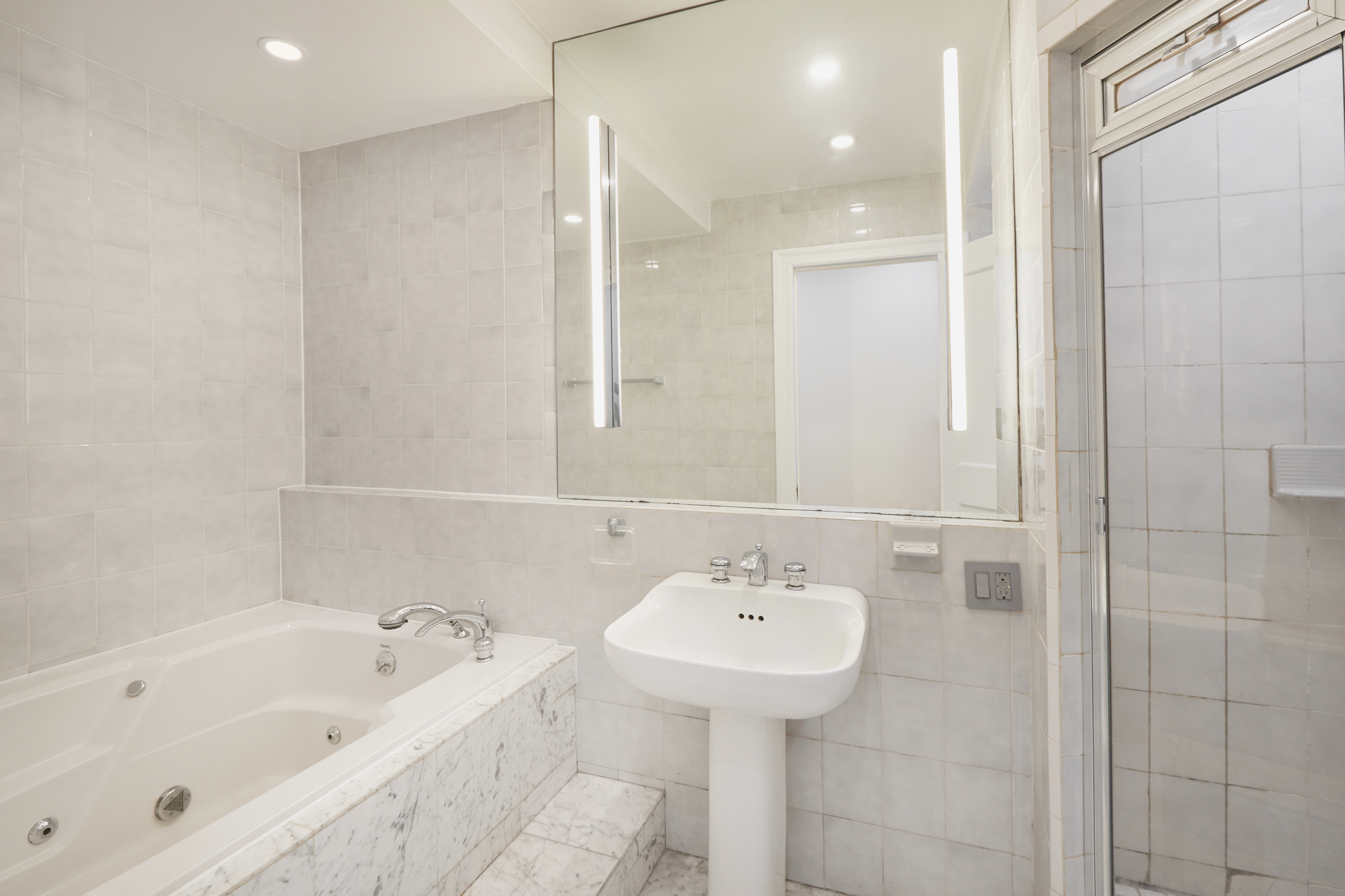 157 East 75th Street, Unit 1E Manhattan, NY 10021 - Photo 9 of 21 a bathroom with a sink and a bathtub
