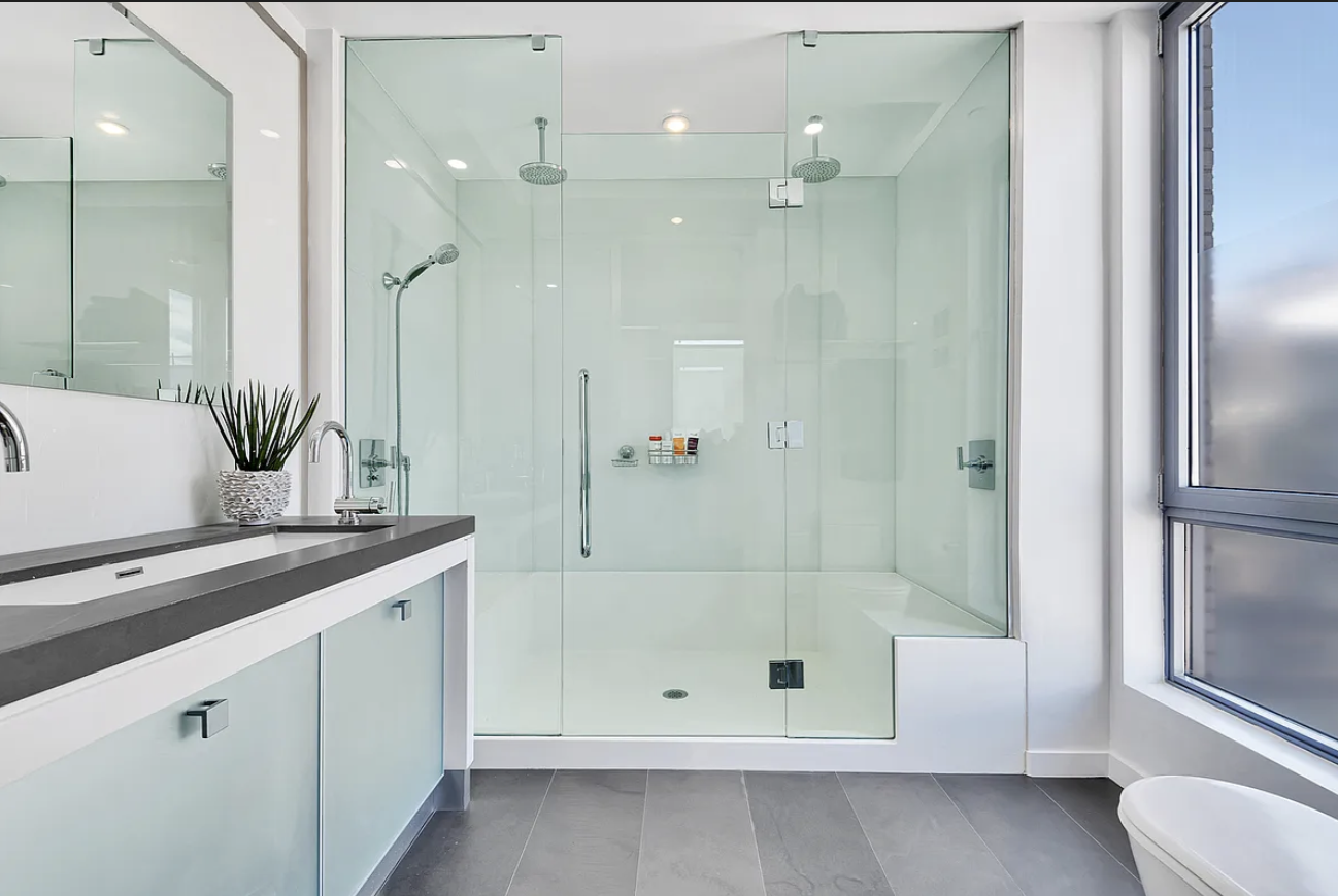 444 West 19th Street, Unit PH1 Manhattan, NY 10011 - Photo 5 of 8 a bathroom with a shower sink and mirror