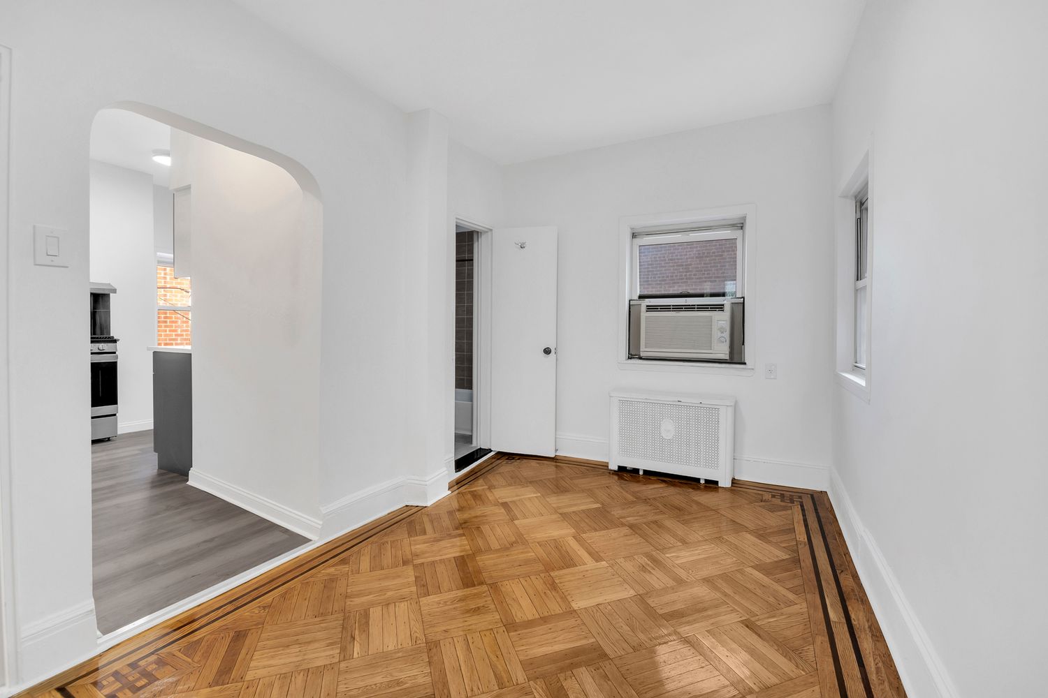 7001 Shore Road, Unit 2 Brooklyn, NY 11209 - Photo 7 of 17 a view of a big room with wooden floor and a bathroom
