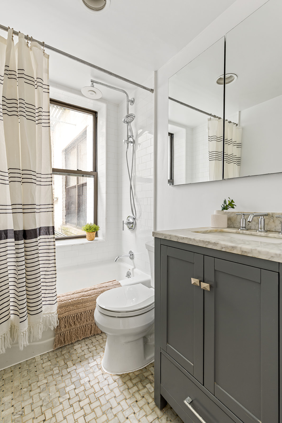 147 South Oxford Street, Unit 2C Brooklyn, NY 11217 - Photo 6 of 12 a bathroom with a granite countertop sink toilet a mirror and shower