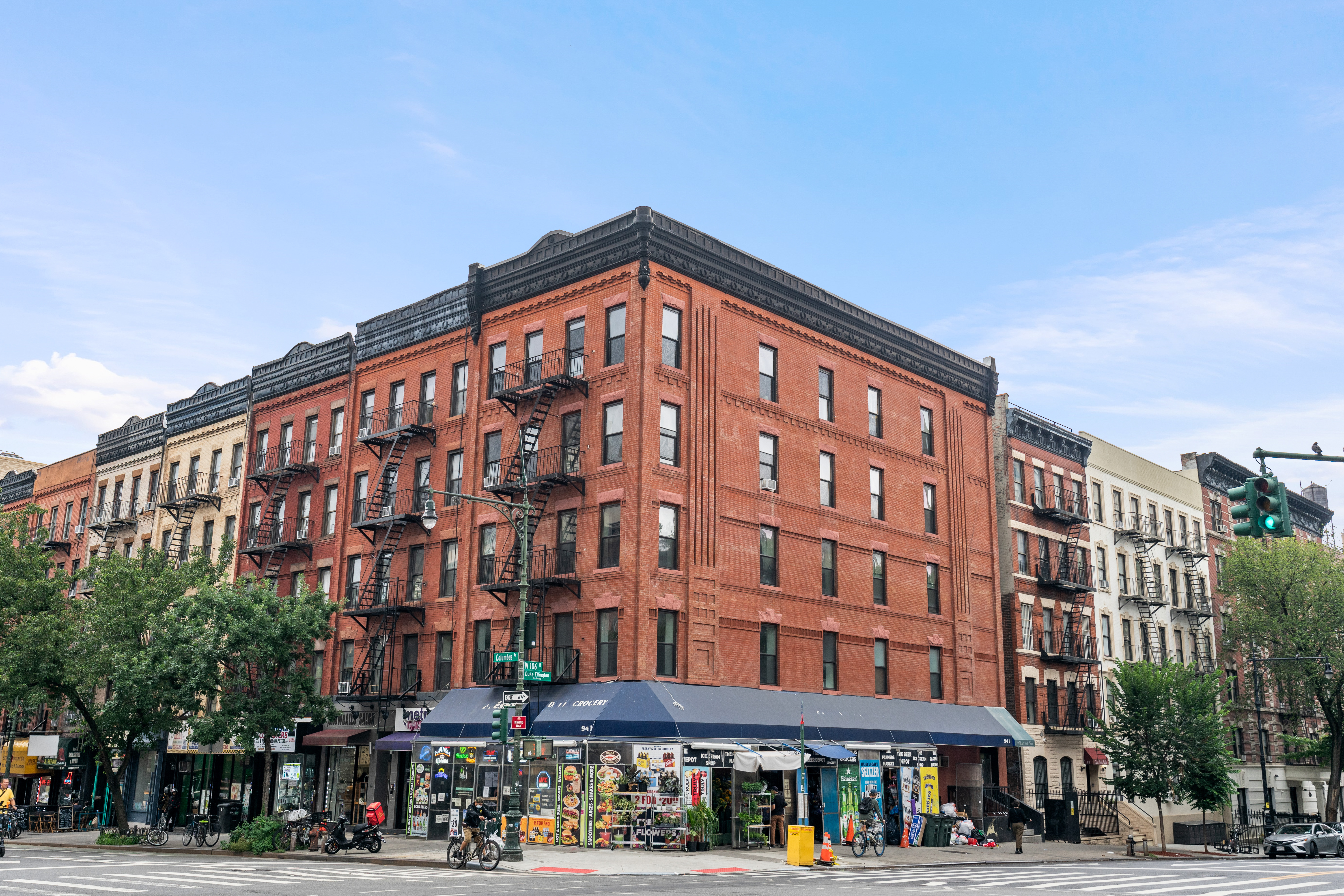 746 9th Avenue, Unit 4DF Manhattan, NY 10019 - Photo 11 of 13 a front view of a building with lot of cars and trees