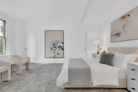 a bedroom with a bed and lamp