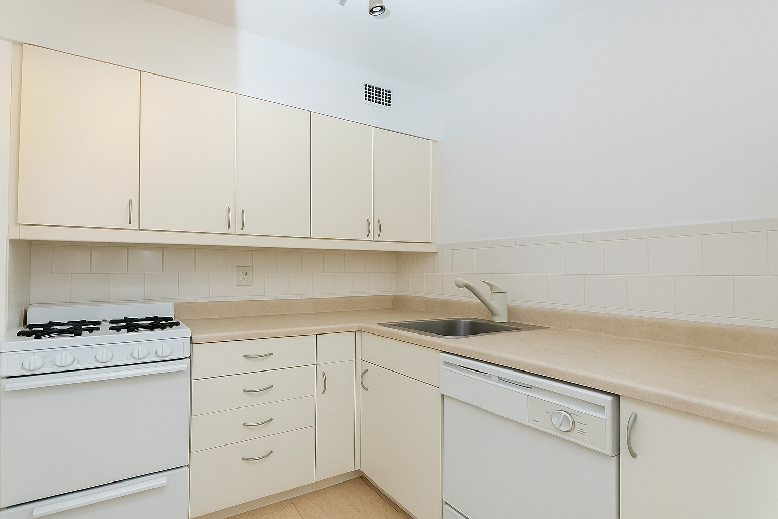 229 East 29th Street, Unit 5N Manhattan, NY 10016 - Photo 2 of 5 a kitchen with white cabinets and appliances