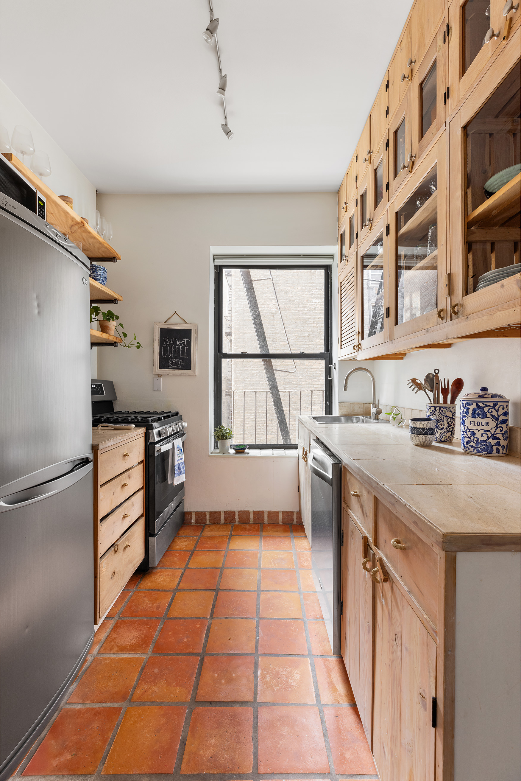 310 West 99th Street, Unit 308 Manhattan, NY 10025 - Photo 7 of 10 a kitchen with stainless steel appliances a stove and a refrigerator