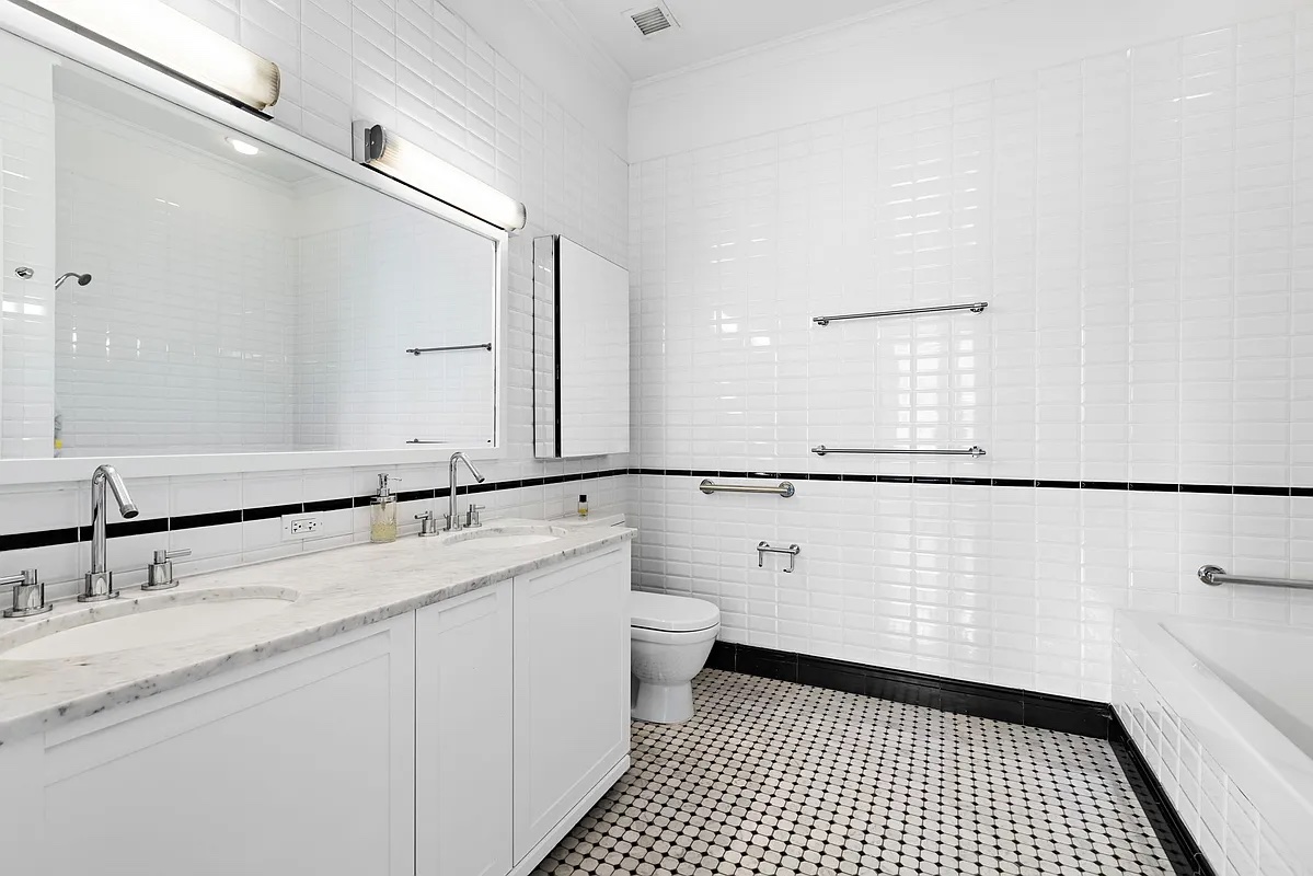 655 6th Avenue, Unit 5E Manhattan, NY 10010 - Photo 9 of 15 a bathroom with a sink a toilet and a mirror