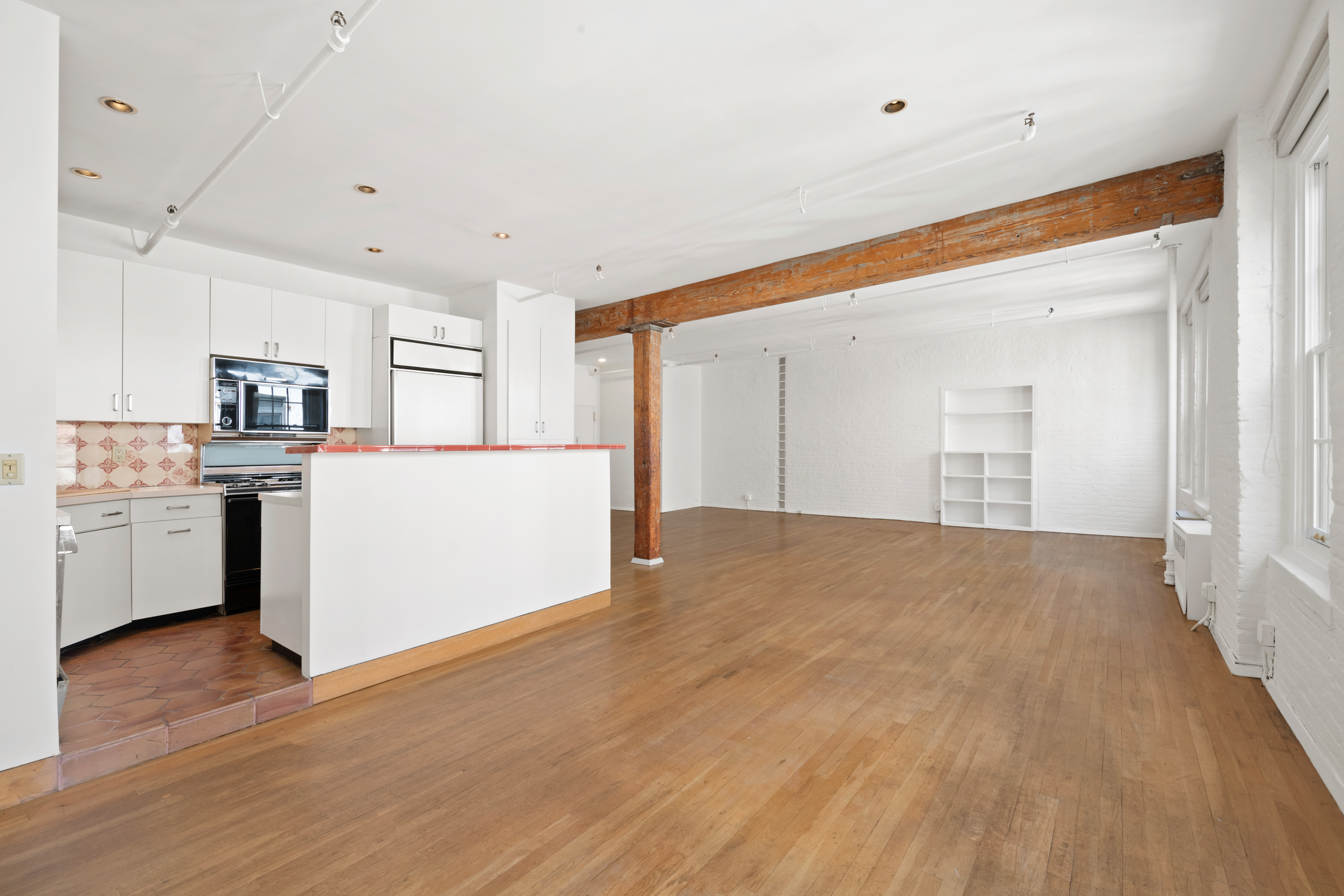 140 Thompson, Unit 4A Manhattan, NY 10012 - Photo 9 of 13 a view of a kitchen with a sink cabinets and wooden floor