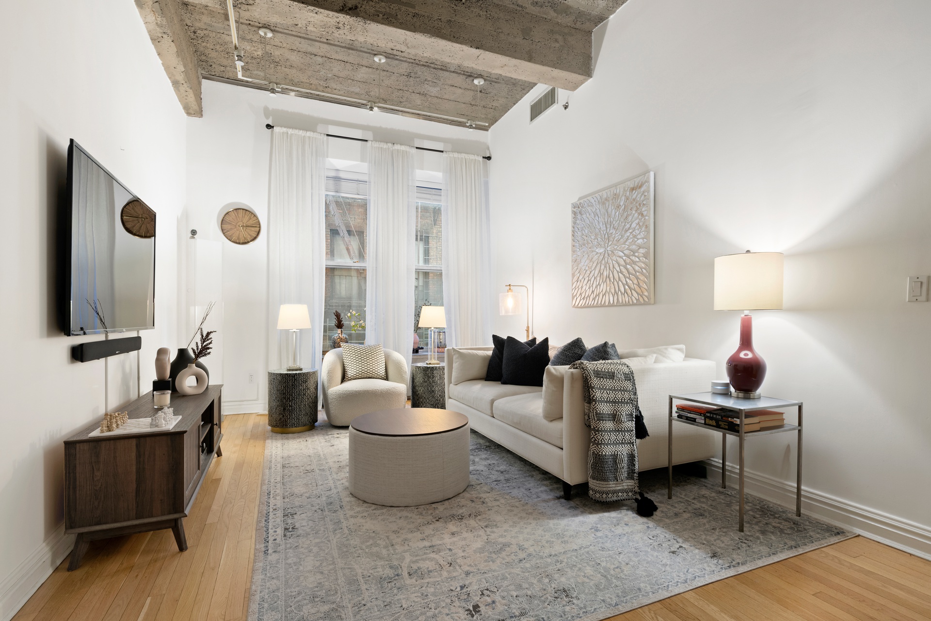 419 West 55th Street, Unit 2D Manhattan, NY 10019 - Photo 1 of 10 a living room with furniture and a flat screen tv