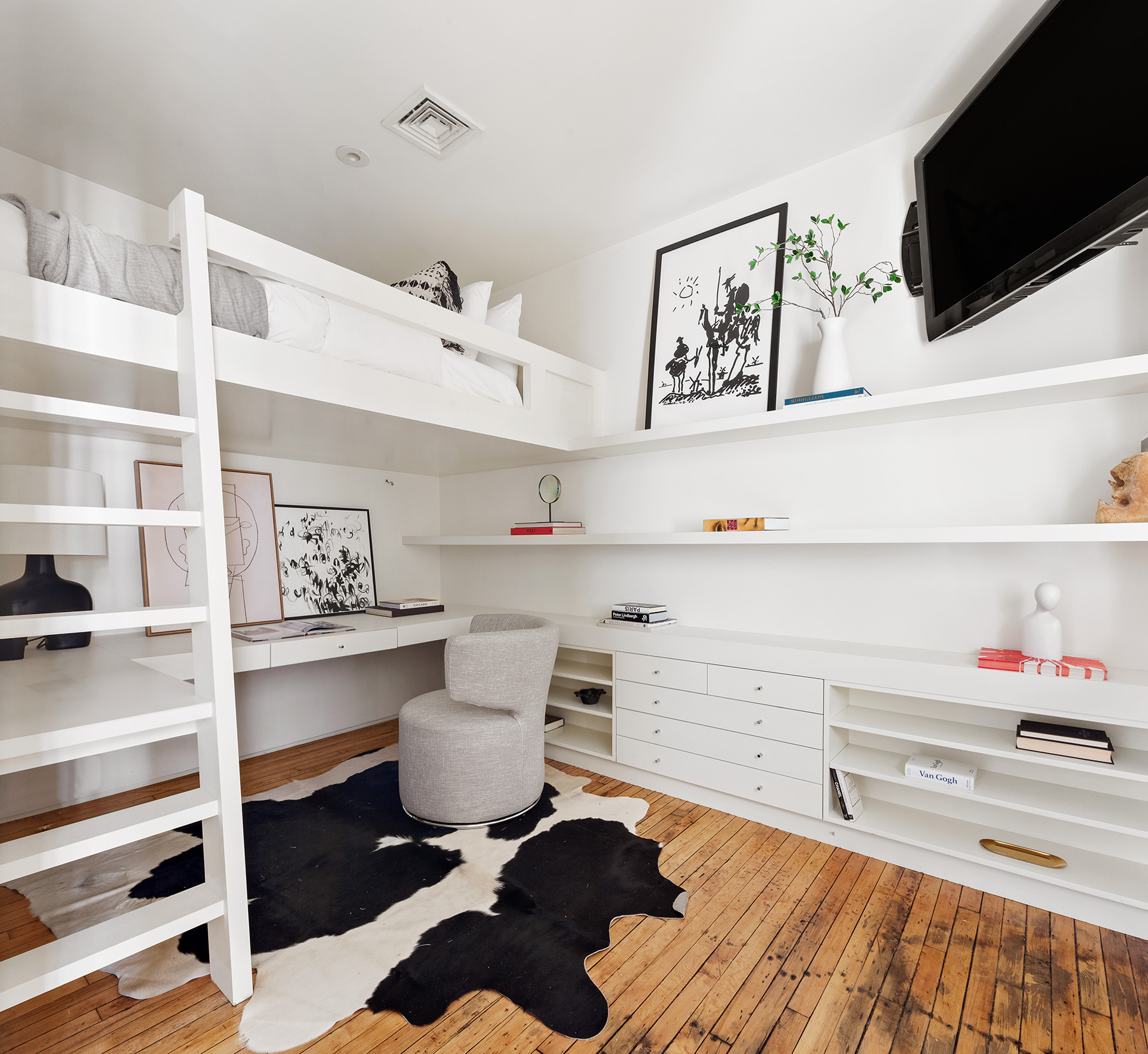 145 6th Avenue, Unit 2B Manhattan, NY 10013 - Photo 21 of 23 a bedroom with a bed and a bookshelf with wooden floor