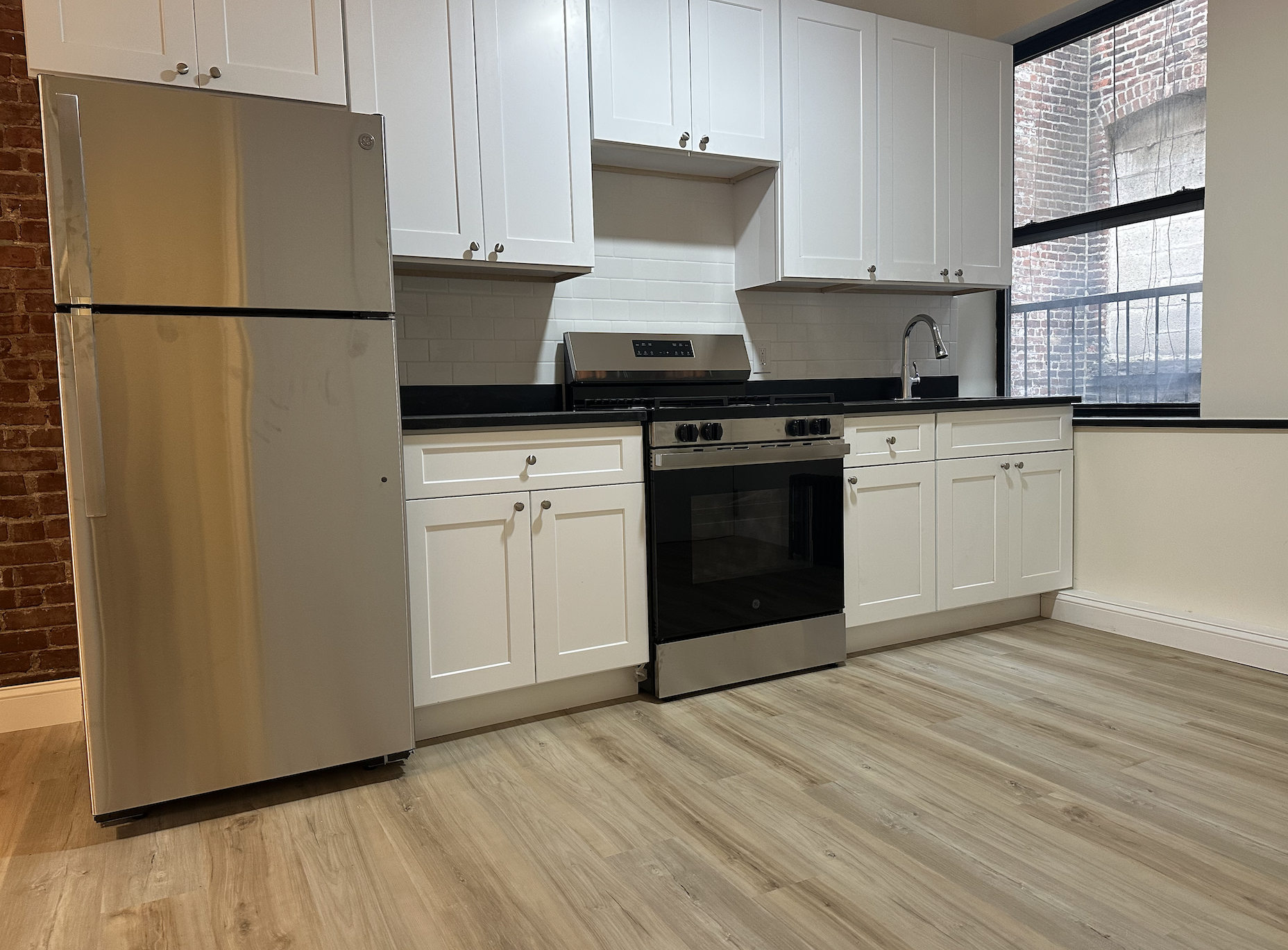 458 West 57th Street, Unit 4FE Manhattan, NY 10019 - Photo 10 of 13 a kitchen with a refrigerator and a stove