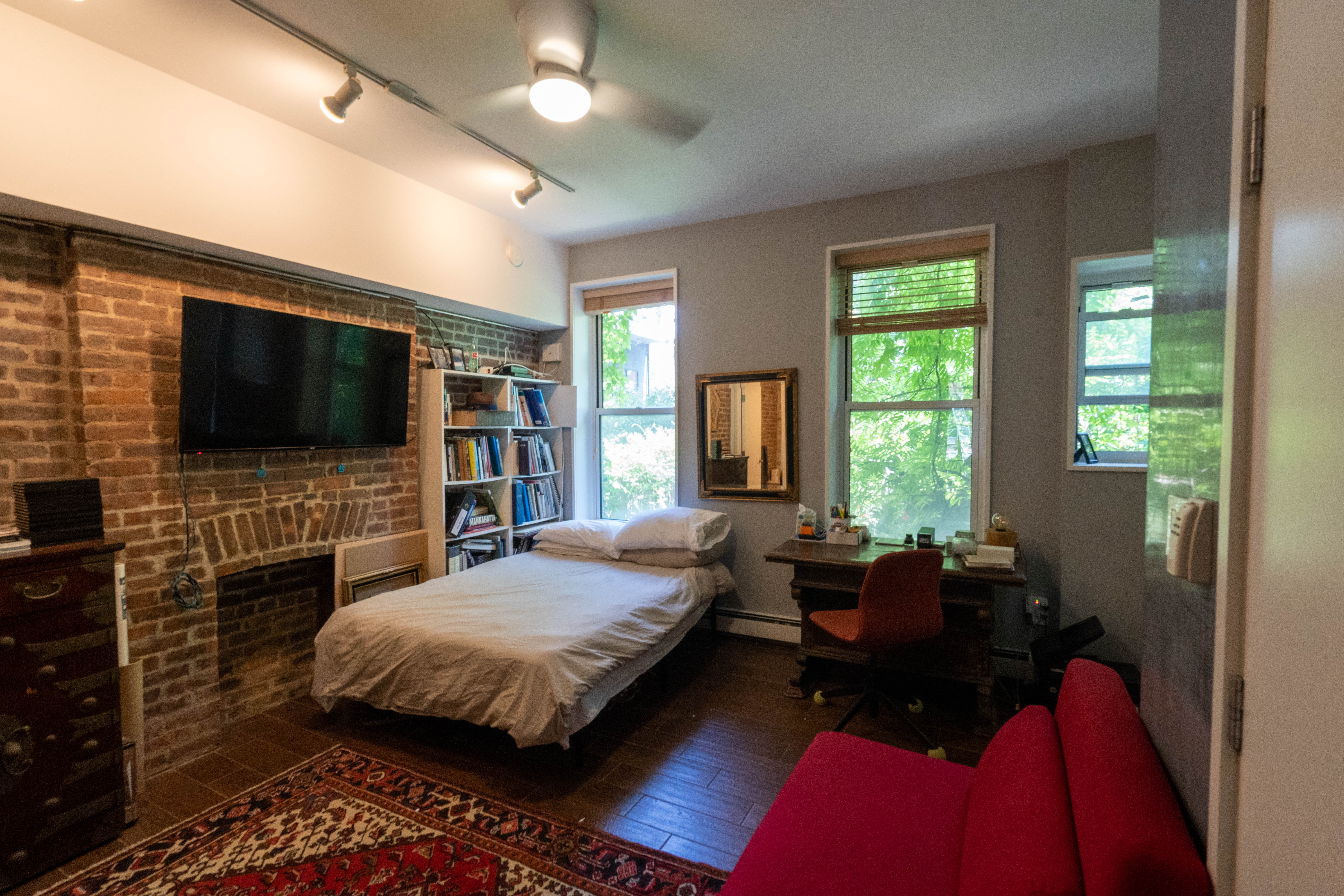 373 Van Brunt Street, Unit 1 Brooklyn, NY 11231 - Photo 3 of 6 a spacious bedroom with a bed and a flat screen tv