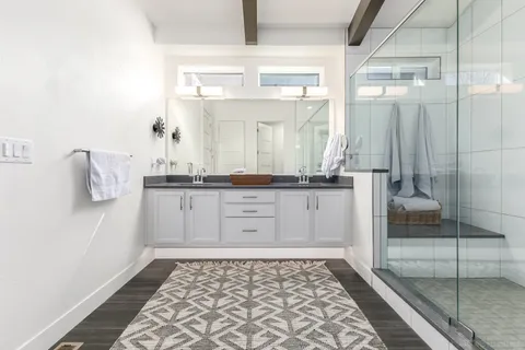 a bathroom with a shower and a mirror