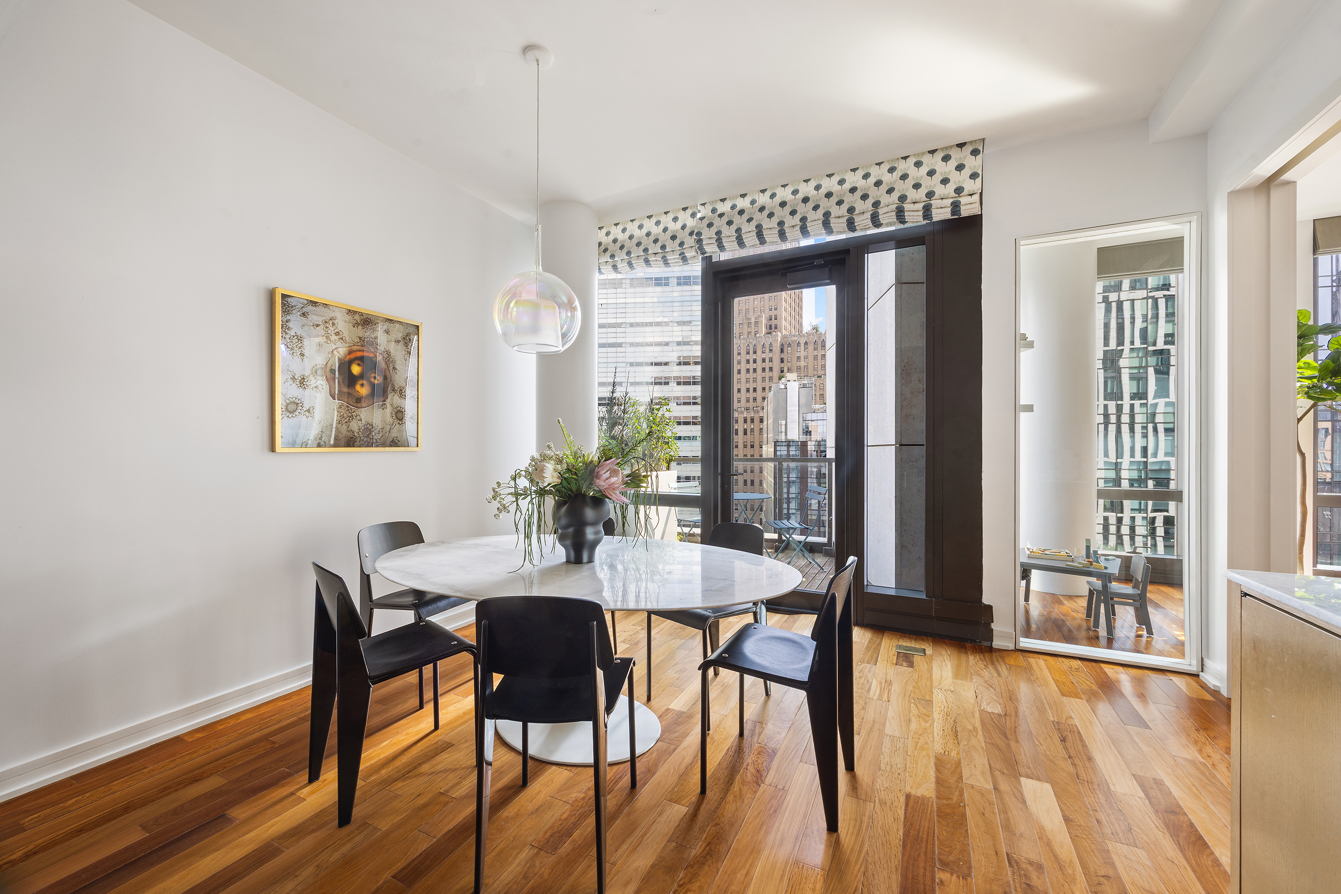 101 Warren Street, Unit 12L Manhattan, NY 10007 - Photo 10 of 28 a view of a dining room with furniture and wooden floor