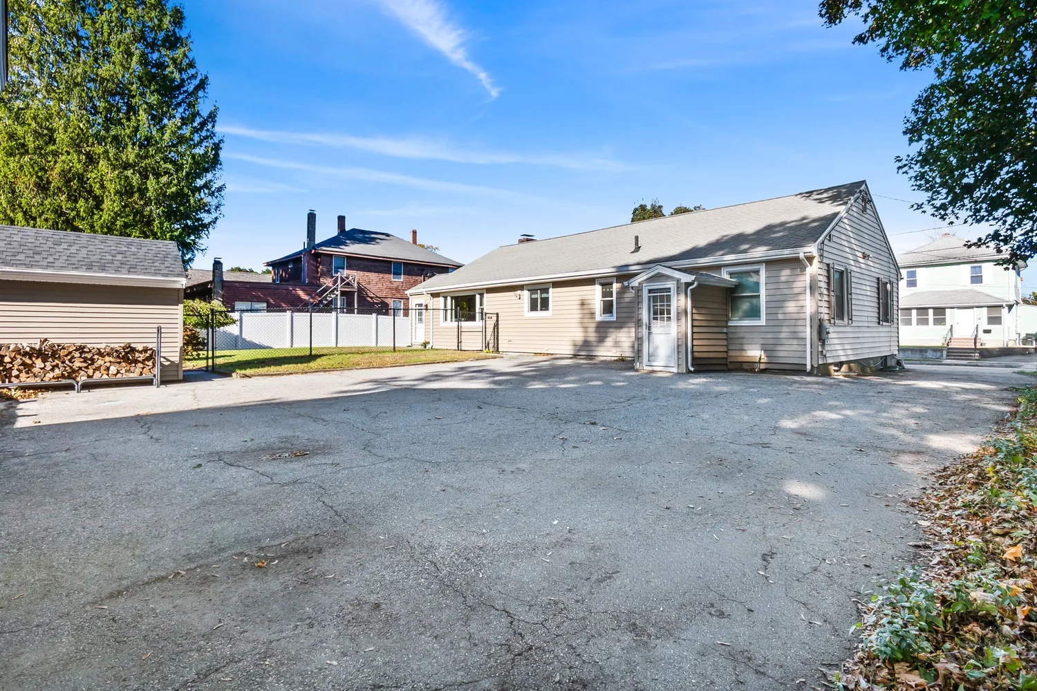 a front view of a house with a yard and outdoor seating