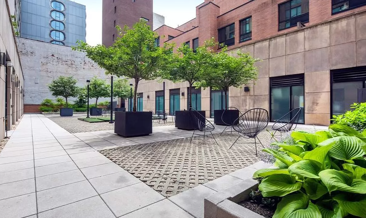 540 West 28th Street, Unit 4F Manhattan, NY 10001 - Photo 14 of 16 a view of a house with potted plants and a bench