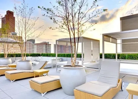 a view of pool with outdoor seating and city view