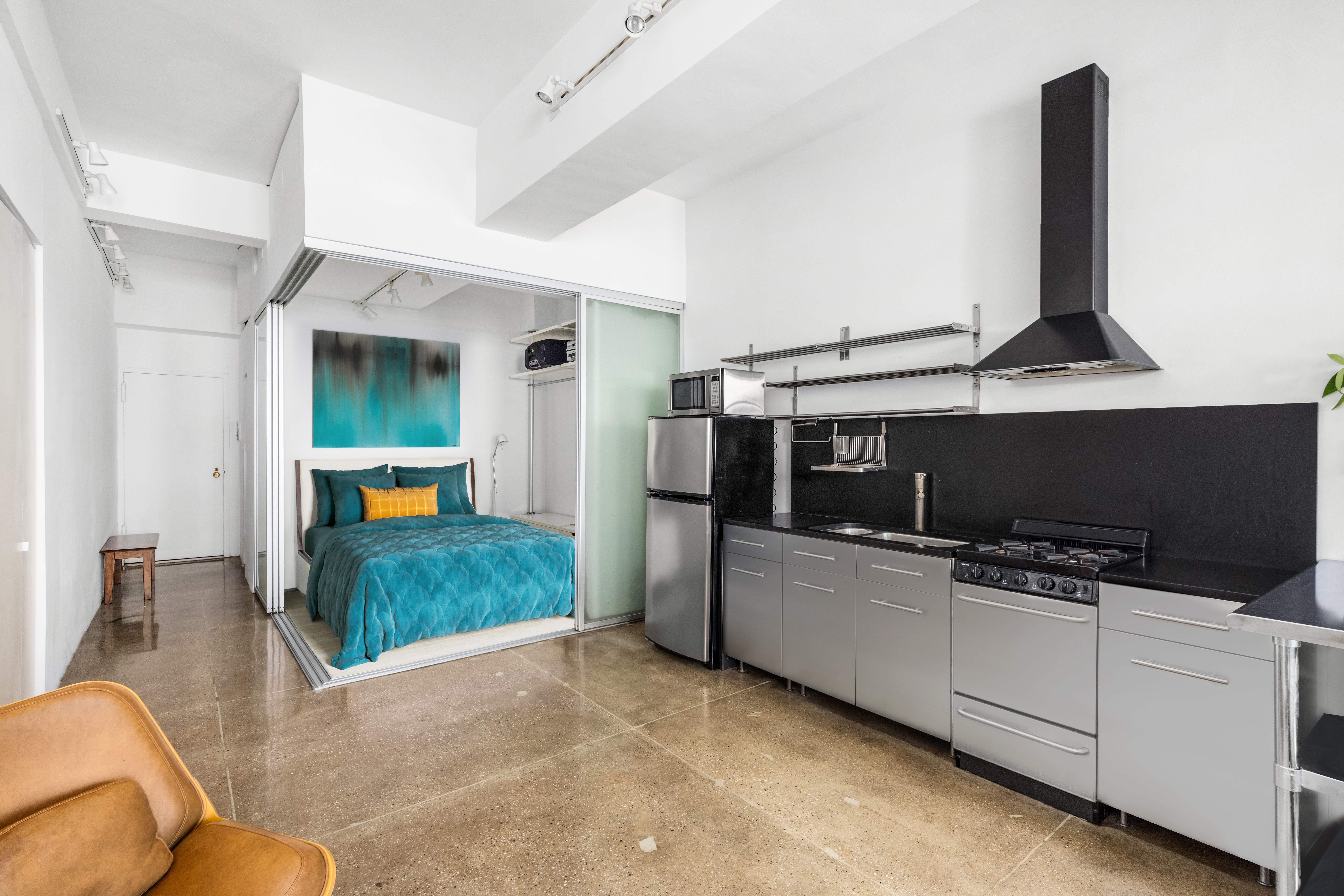 315 7th Avenue, Unit 6C Manhattan, NY 10001 - Photo 6 of 10 a room with furniture and a flat screen tv