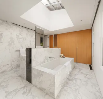 a bathroom with a tub sink and mirror