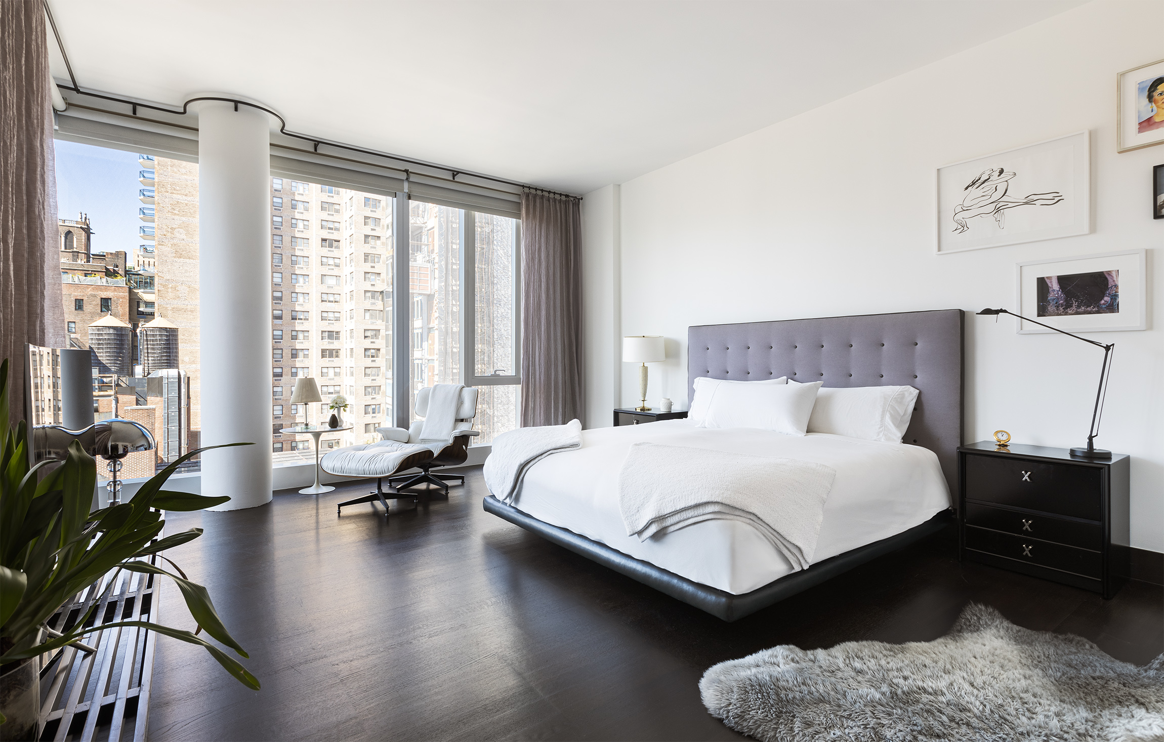 151 East 85th Street, Unit 14A Manhattan, NY 10028 - Photo 7 of 14 a bedroom with a bed couch and a large window