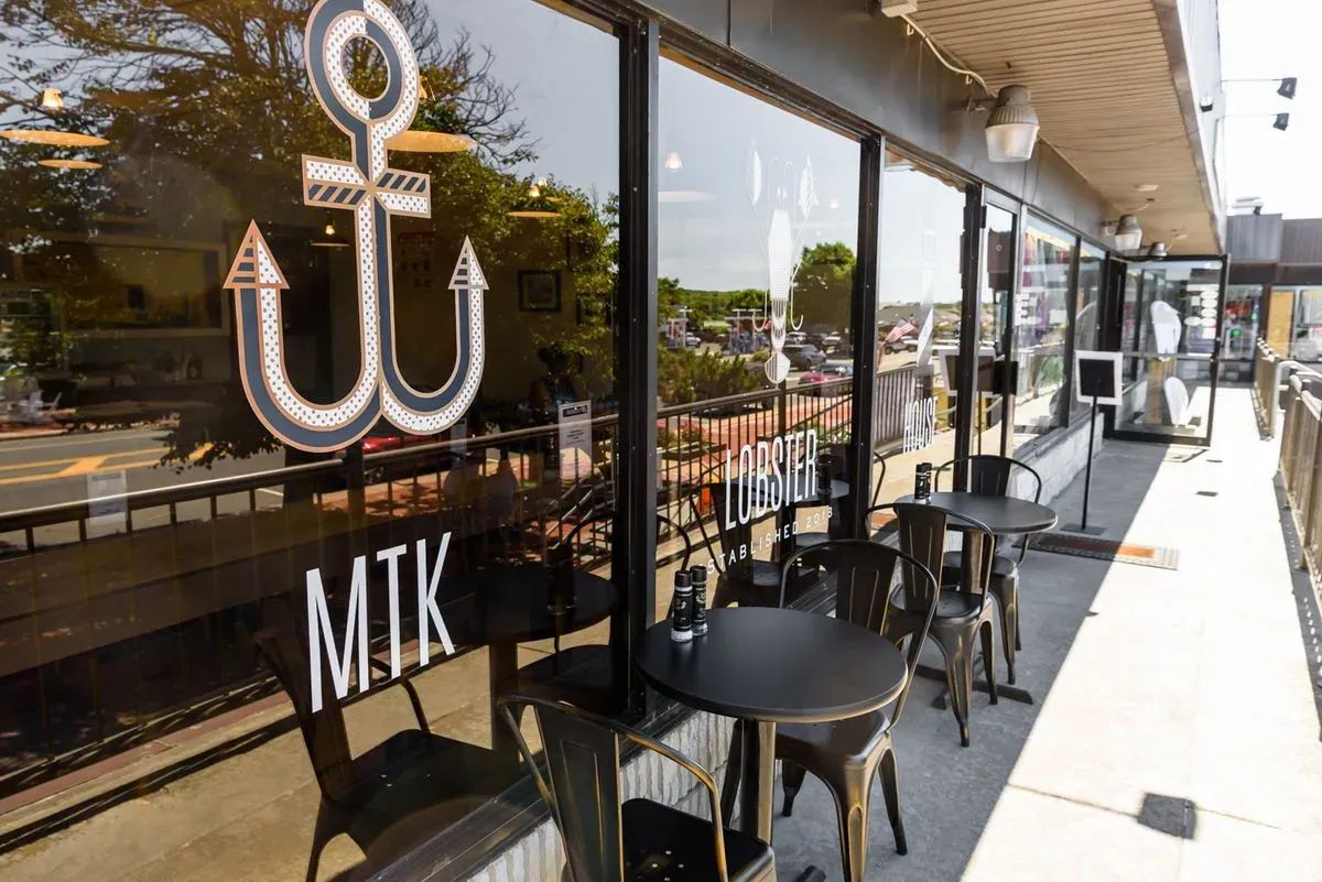 a view of a dining room with furniture wooden floor and a chandelier